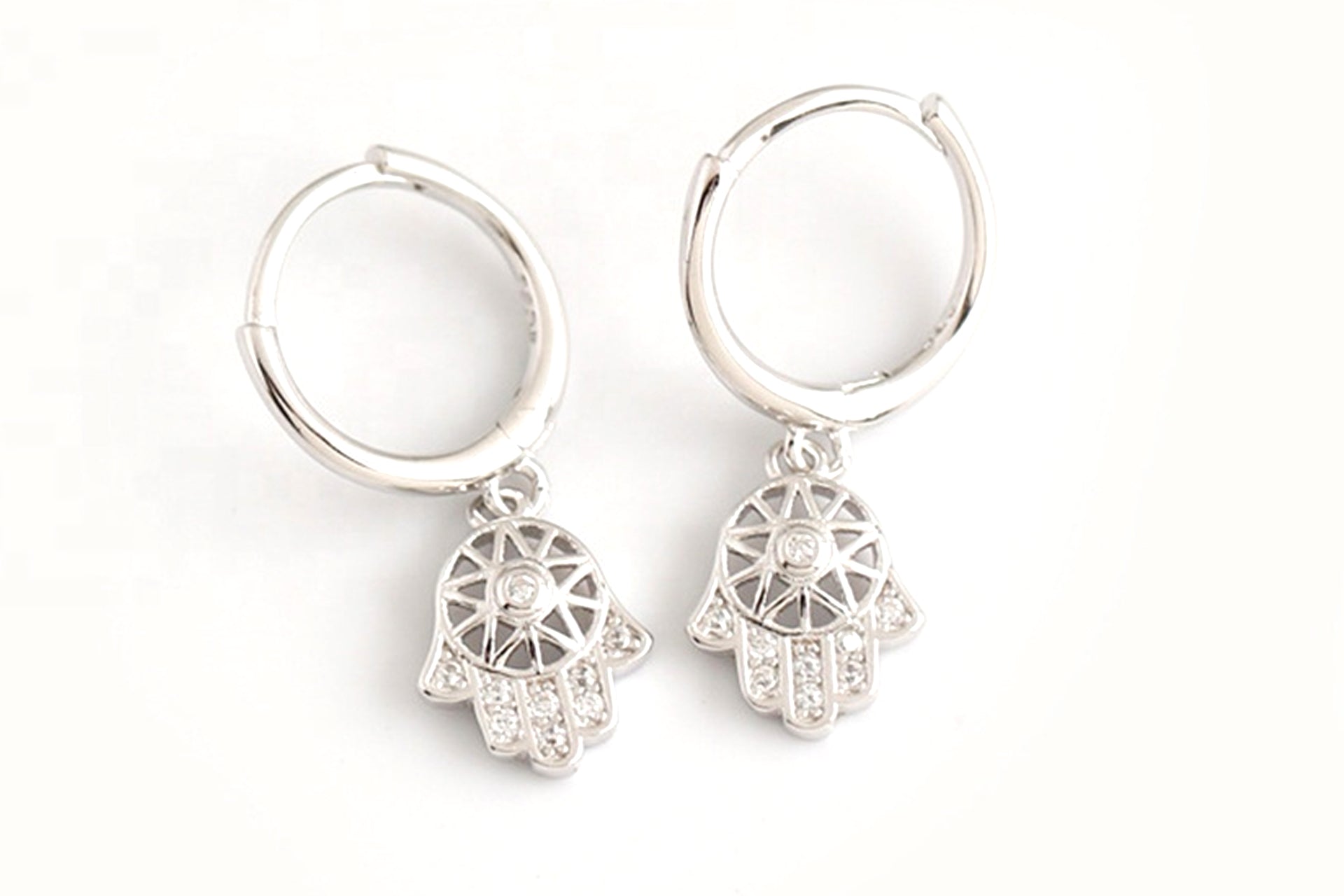 Platinum Plated Hamsa Hand Cut Out Drop Earrings With White Zirconia Embellishment Primal Chakra